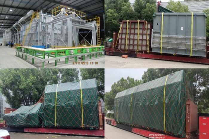 Inside a manufacturing plant: large gray industrial equipment with green framework and yellow safety rails.